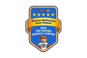 A blue Carfax 2025 Top-Rated Service Center award badge for Tommy Mathewes Auto Repair