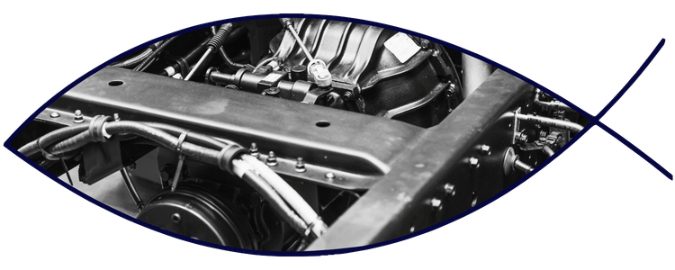 Blue car-shaped keychains displayed on the front desk, with a BMW mug and a Christian fish symbol sign in the background.