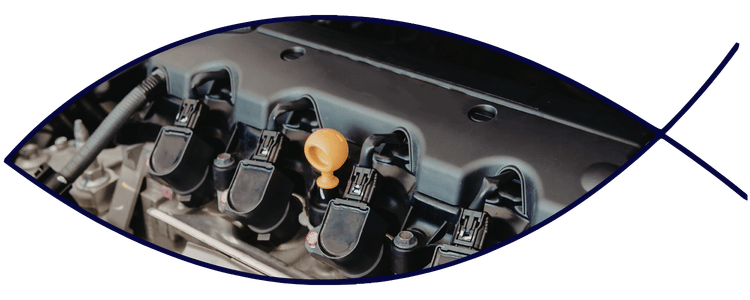 Blue car-shaped keychains displayed on the front desk, with a BMW mug and a Christian fish symbol sign in the background.