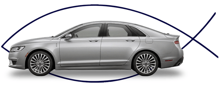 Blue car-shaped keychains displayed on the front desk, with a BMW mug and a Christian fish symbol sign in the background.