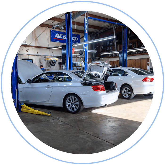 Routine maintenance service with multiple vehicles in repair shop