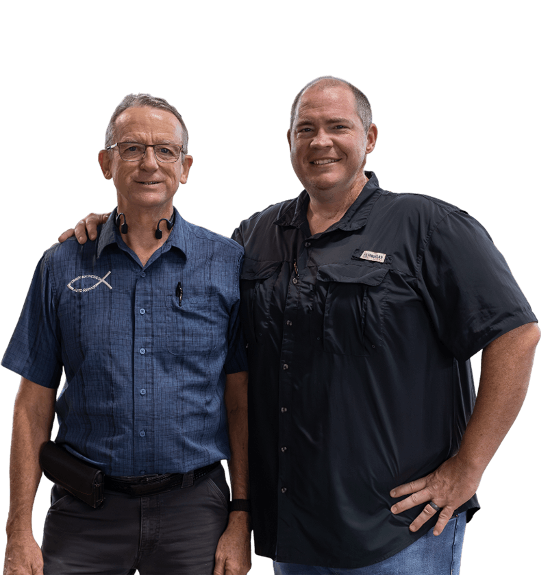 Tommy & Jonathan standing side-by-side against a white background, one in a blue button-down shirt and one in a black polo.