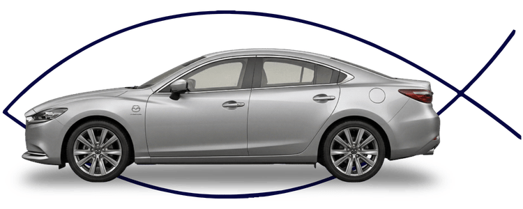 Blue car-shaped keychains displayed on the front desk, with a BMW mug and a Christian fish symbol sign in the background.