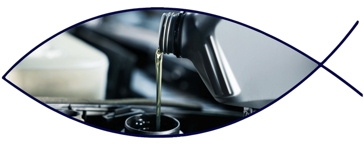 Blue car-shaped keychains displayed on the front desk, with a BMW mug and a Christian fish symbol sign in the background.