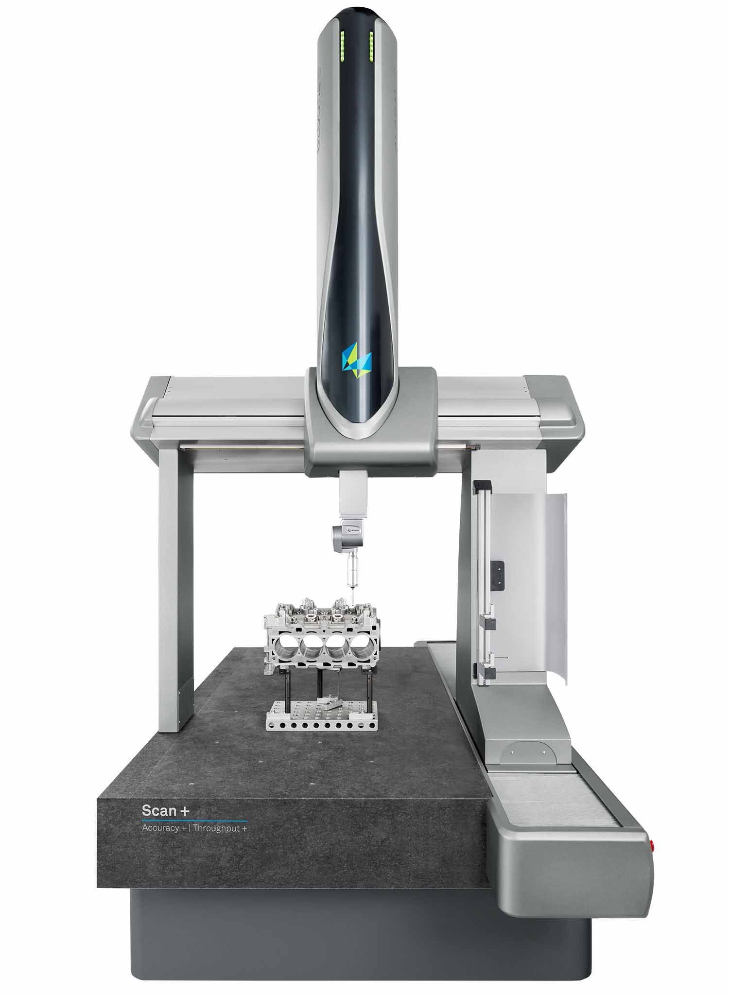 A CMM (coordinate measuring machine) inspecting a metal part; a color map on the monitor displays dimensional data.