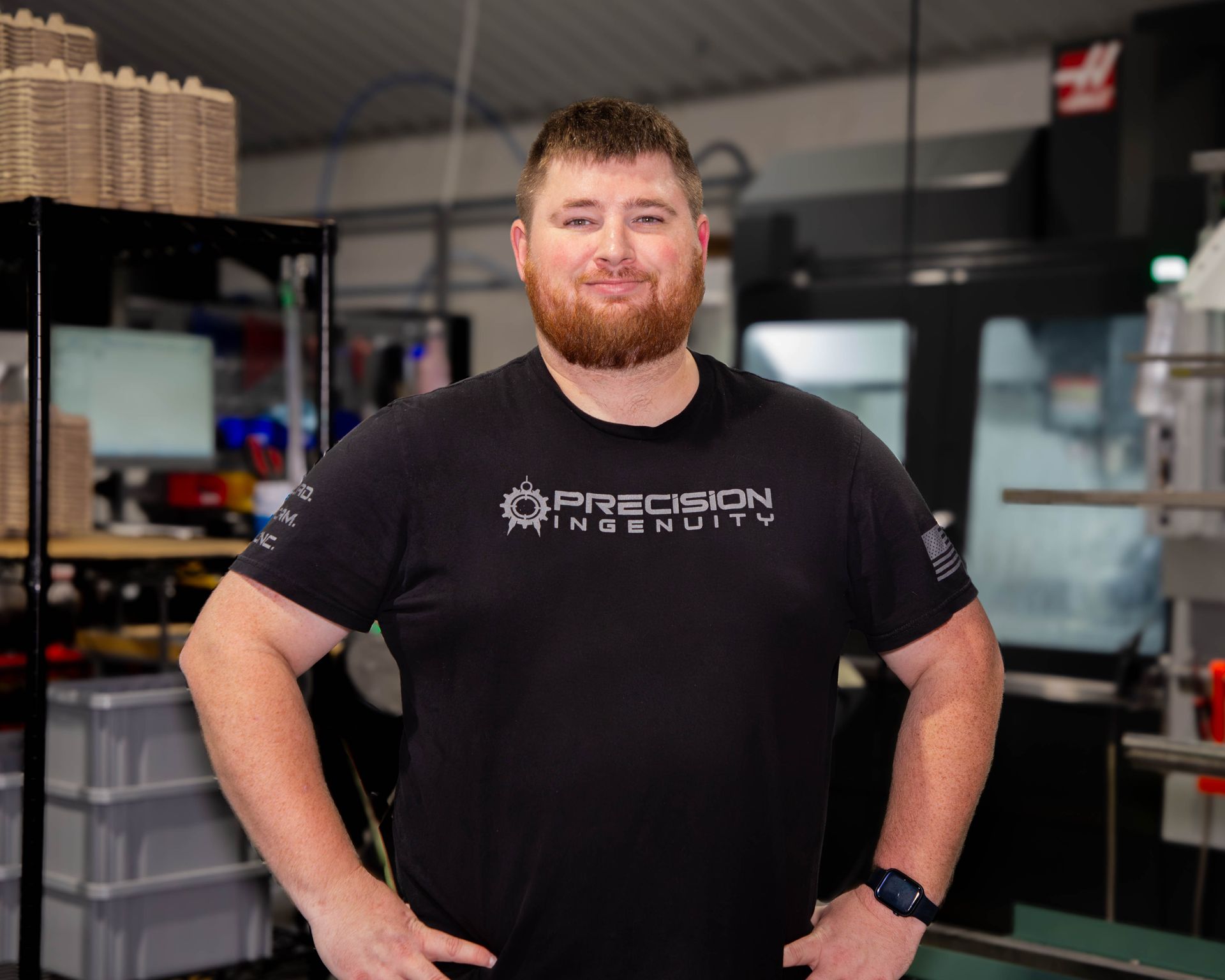 Man with a red beard wearing a black t-shirt that says 