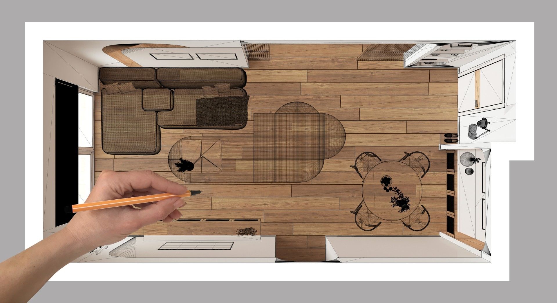 A person is drawing a floor plan of a living room with a pencil.