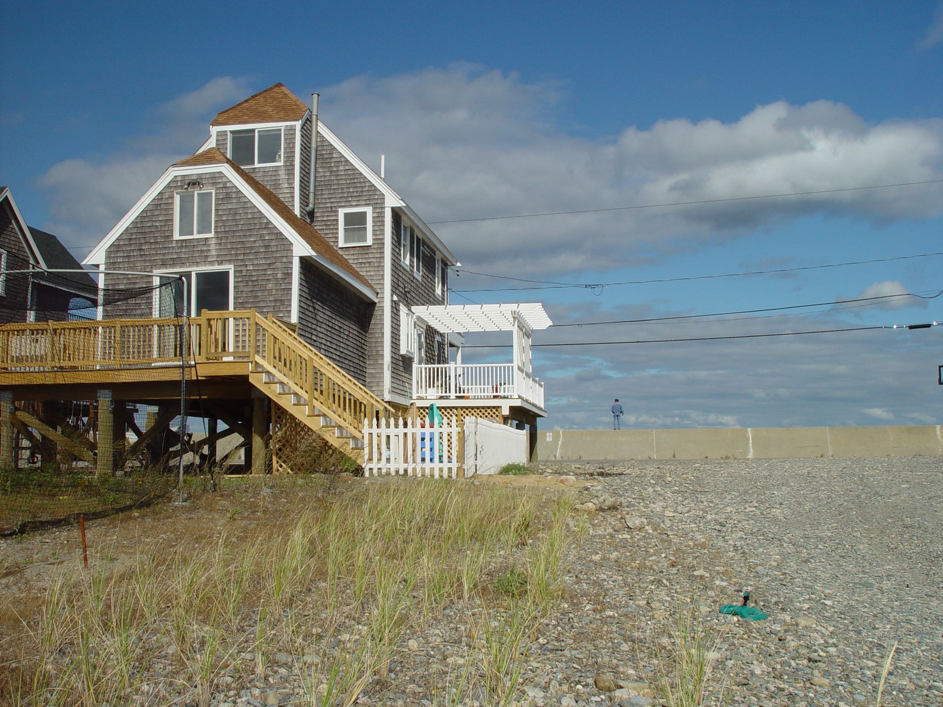 A house with stairs leading up to it is on the beach