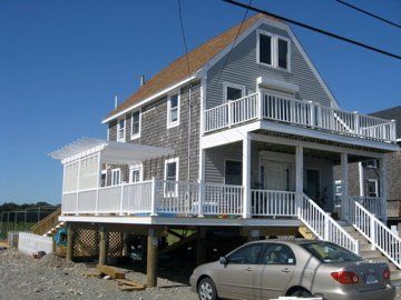 A house with a car parked in front of it