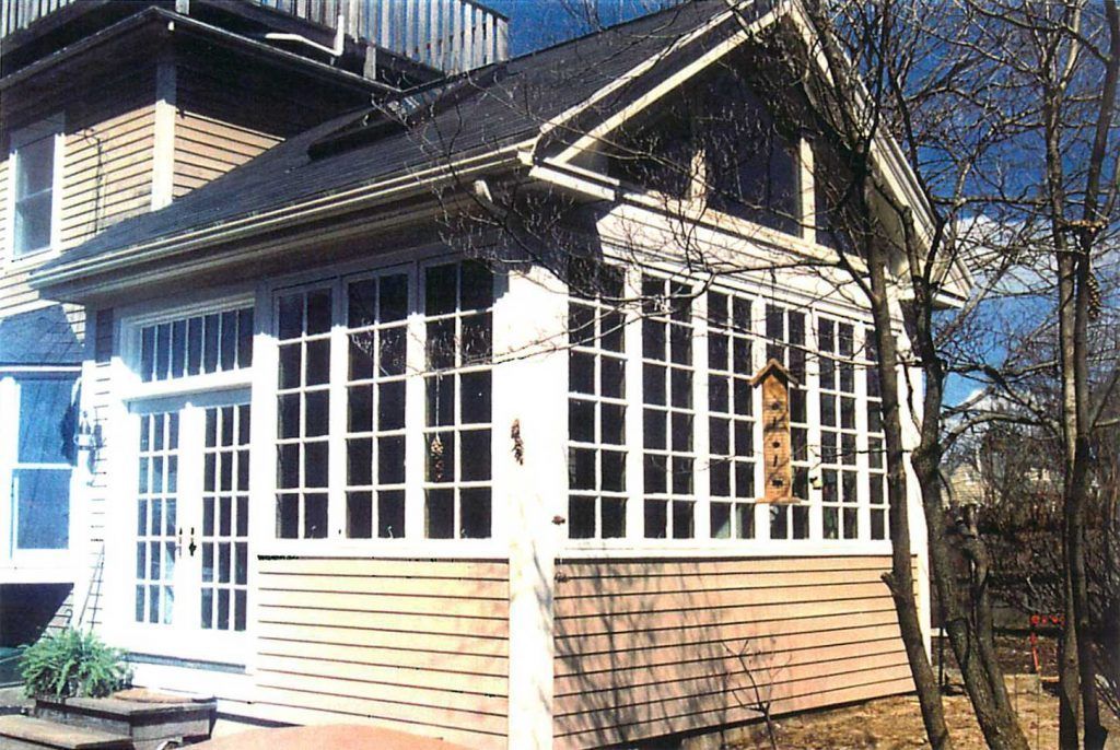 A house with a lot of windows and a roof