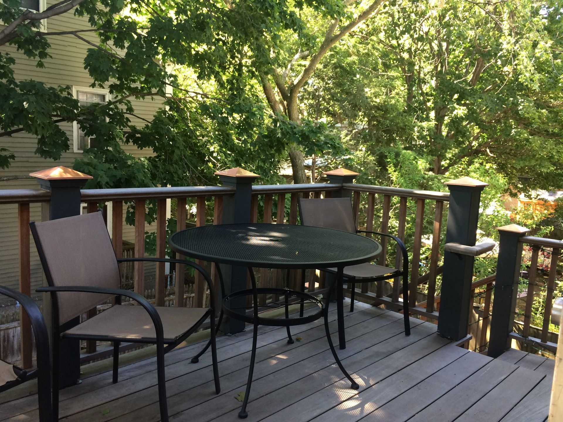A wooden deck with a table and chairs on it