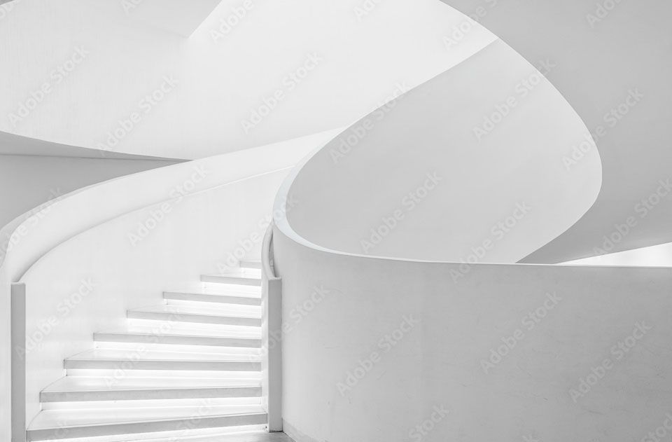 A man is holding a tablet with a model of a building on it.
