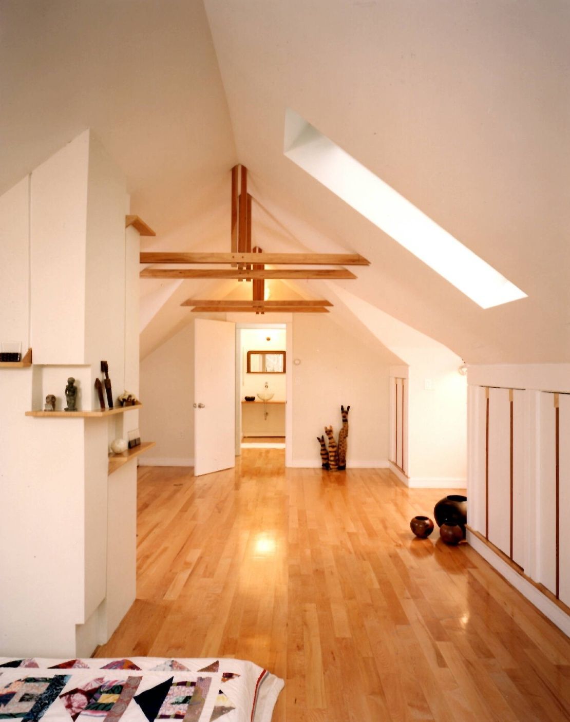 A room with hardwood floors and white walls