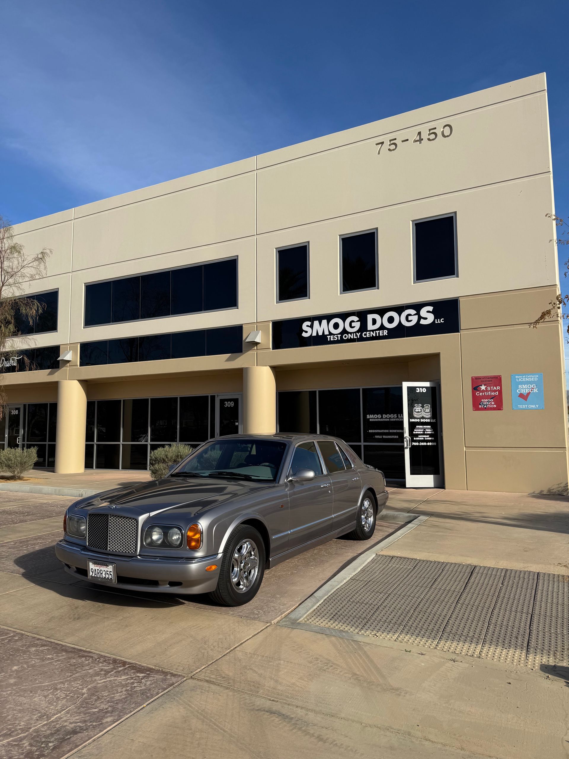 A car is parked in front of a building that says smds dogs