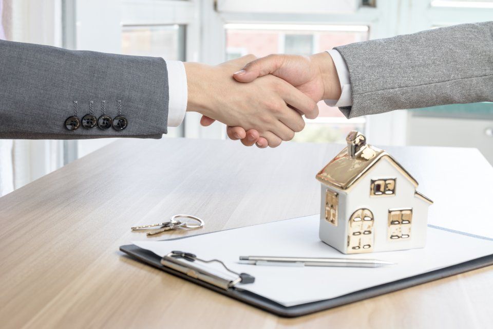 real estate agent shaking hand with the customer