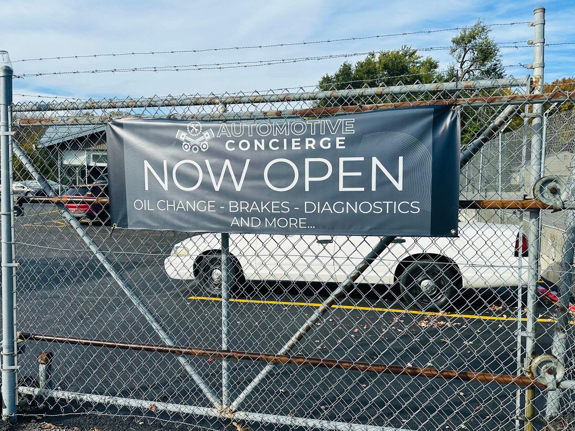 Banner on chain link fence | Automotive Concierge KC