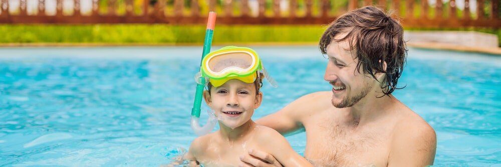 dad and son by the pool - Aqualine Pools Bundaberg