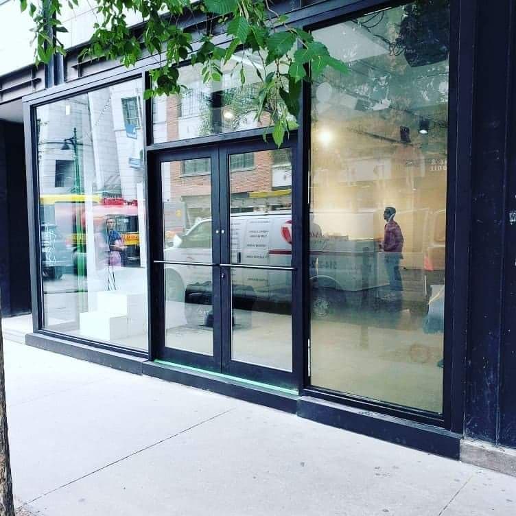 A store front with a white van parked in front of it.