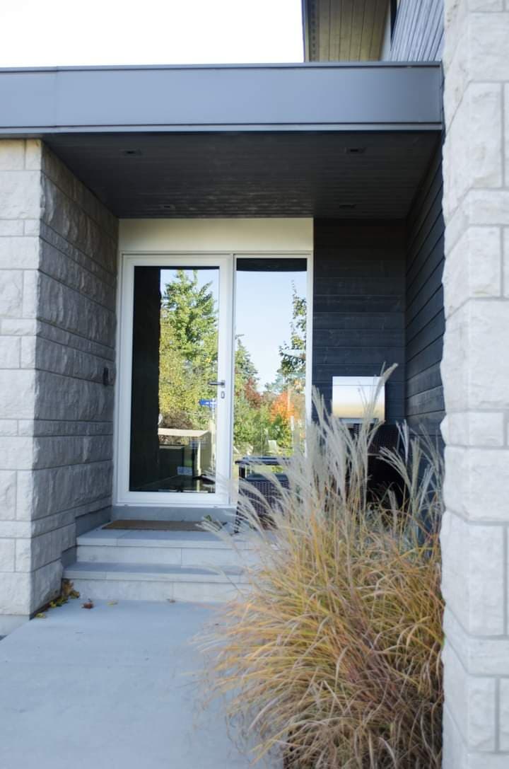 The front door of a house with a sliding glass door.