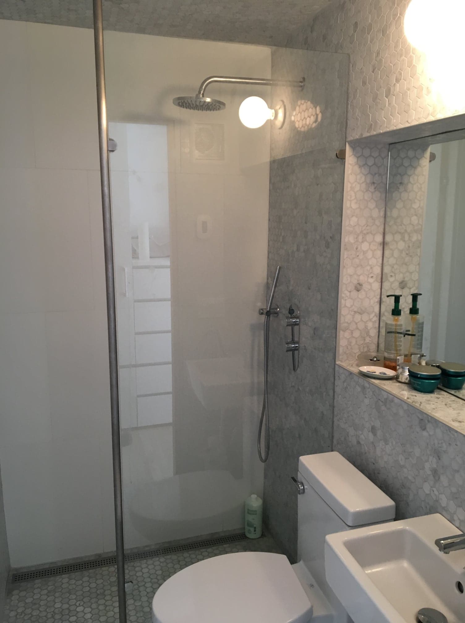 Une salle de bain avec WC, lavabo et douche.