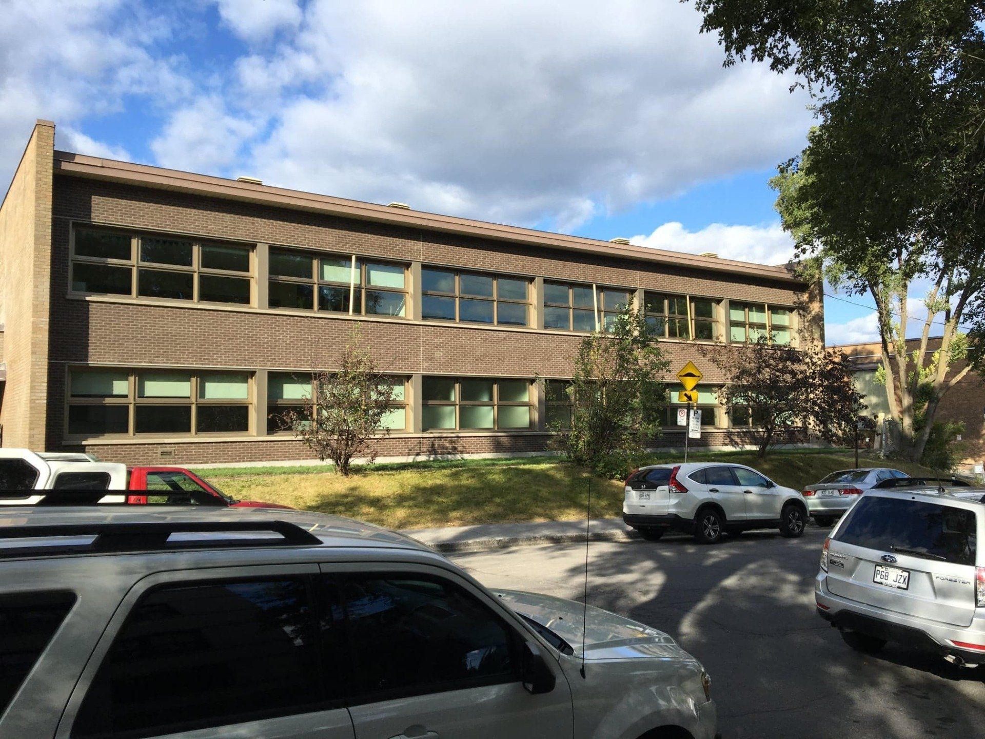 A building with a lot of windows and cars parked in front of it