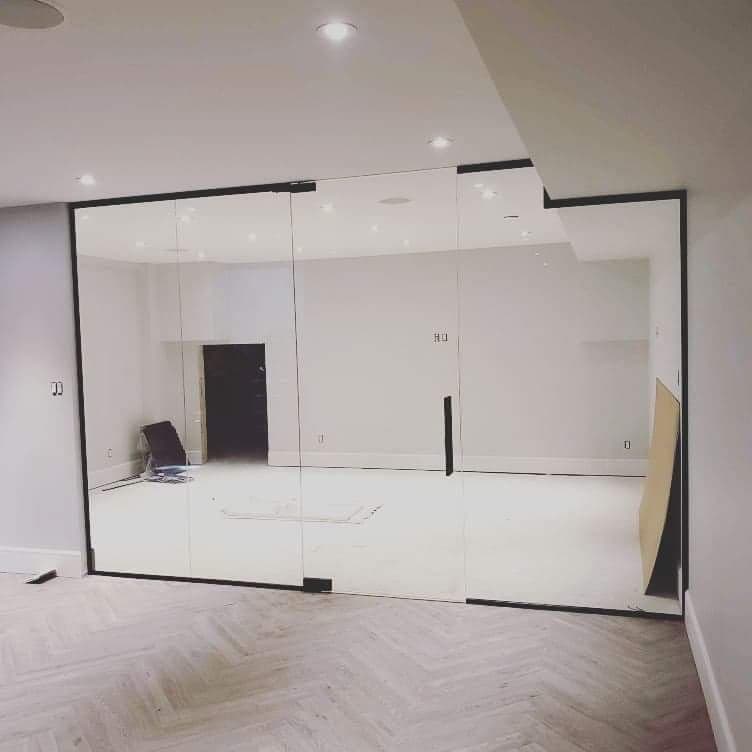 Une pièce avec un mur en verre et des portes coulissantes en verre.