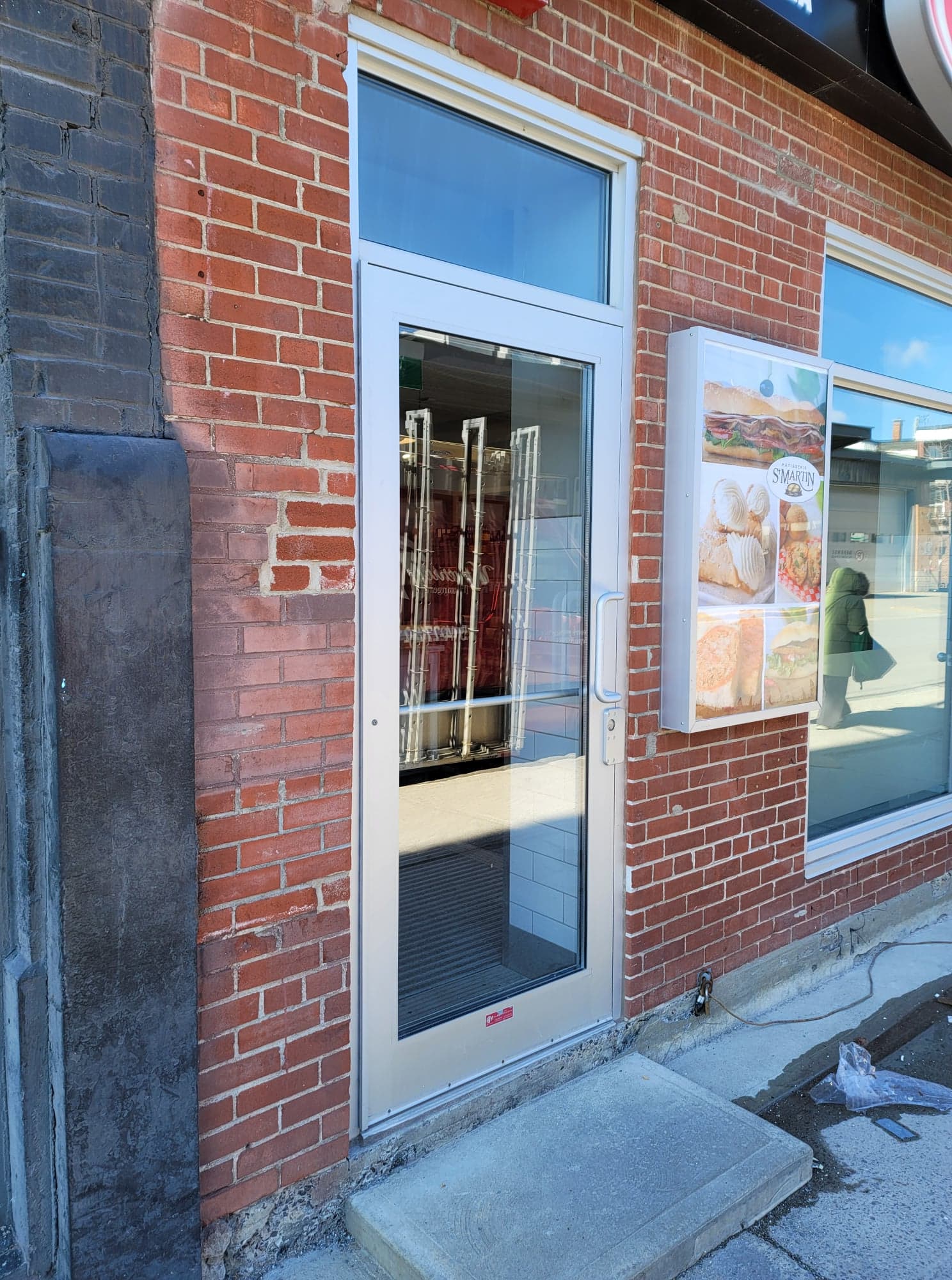 A brick building with a door that is open