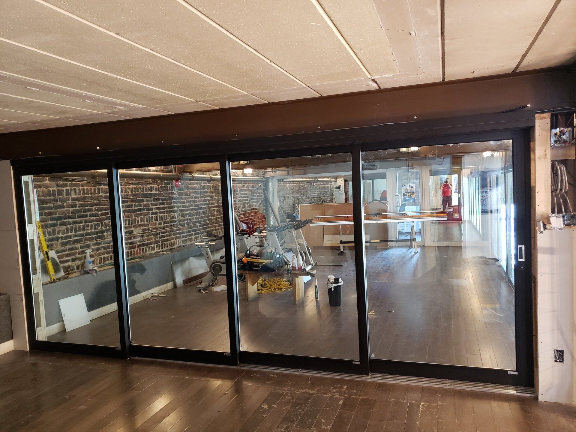 Une grande pièce avec beaucoup de fenêtres et un mur de briques.