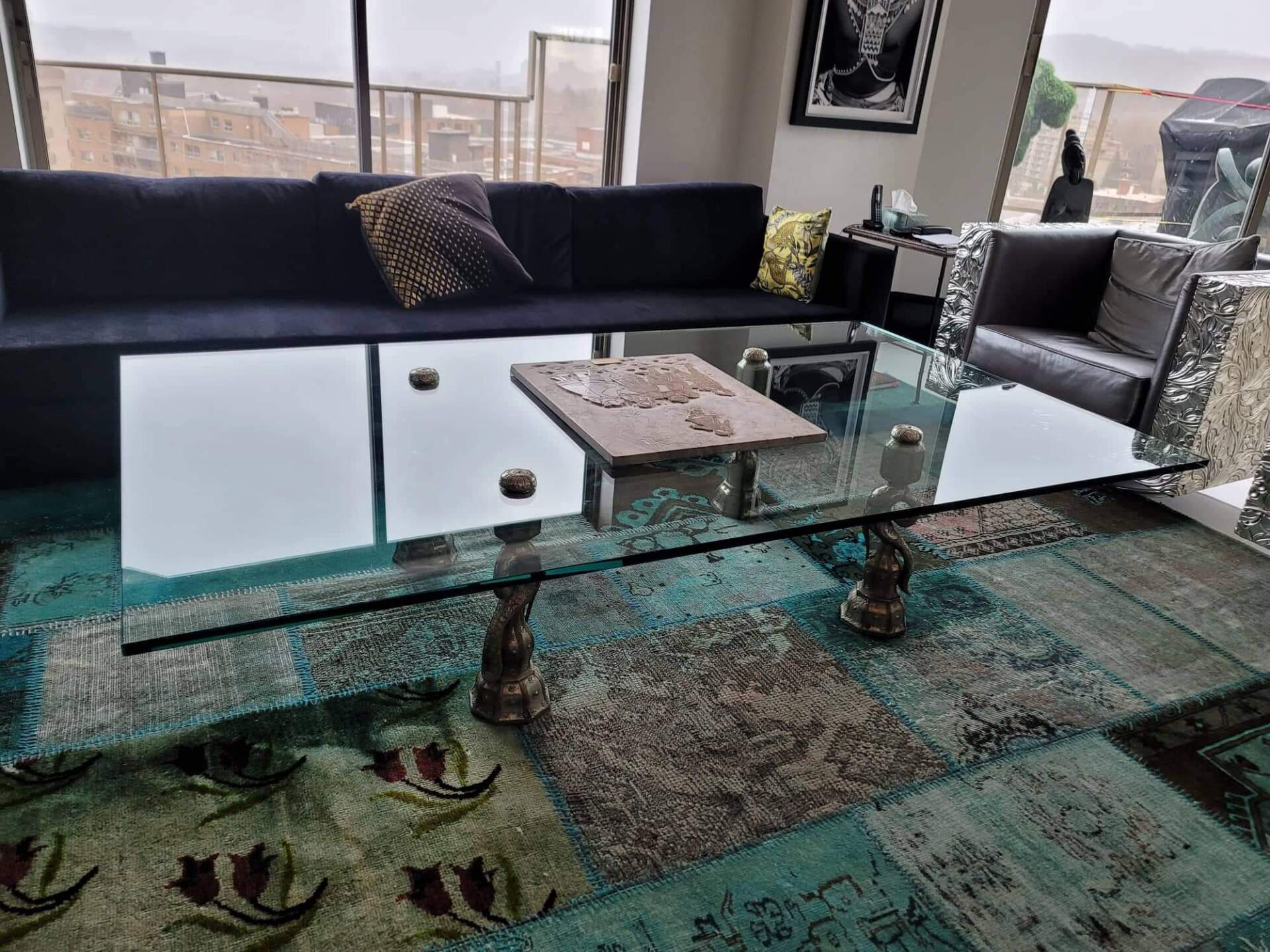 A living room with a couch and a glass coffee table