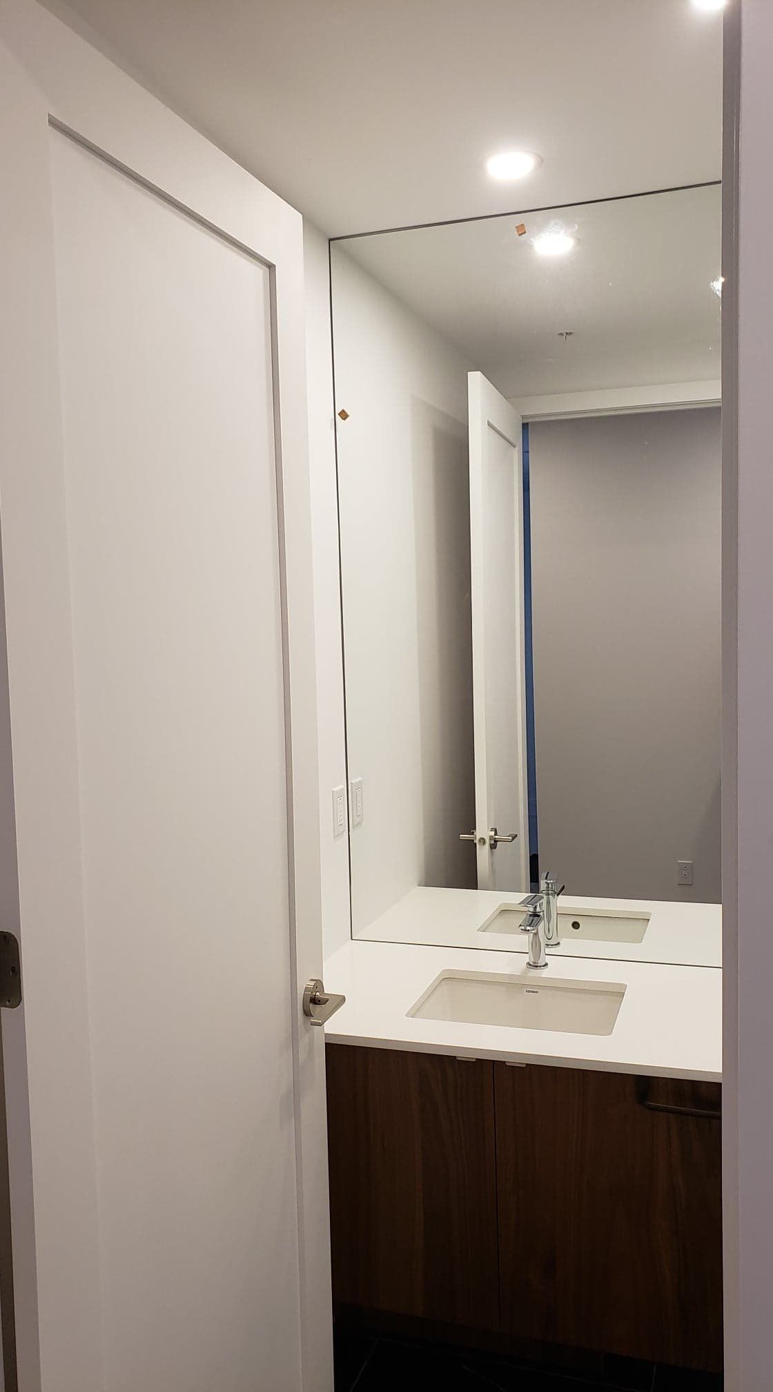 Une salle de bain avec deux lavabos et un grand miroir.