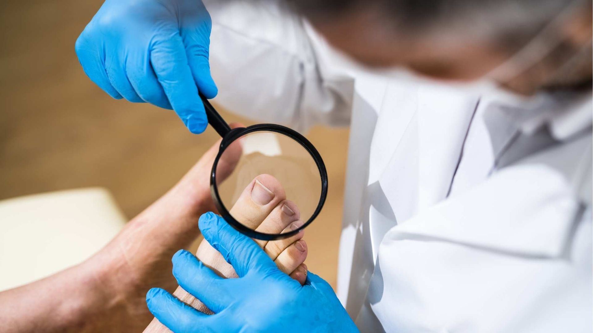 A doctor is examining a patient 's foot with a magnifying glass.