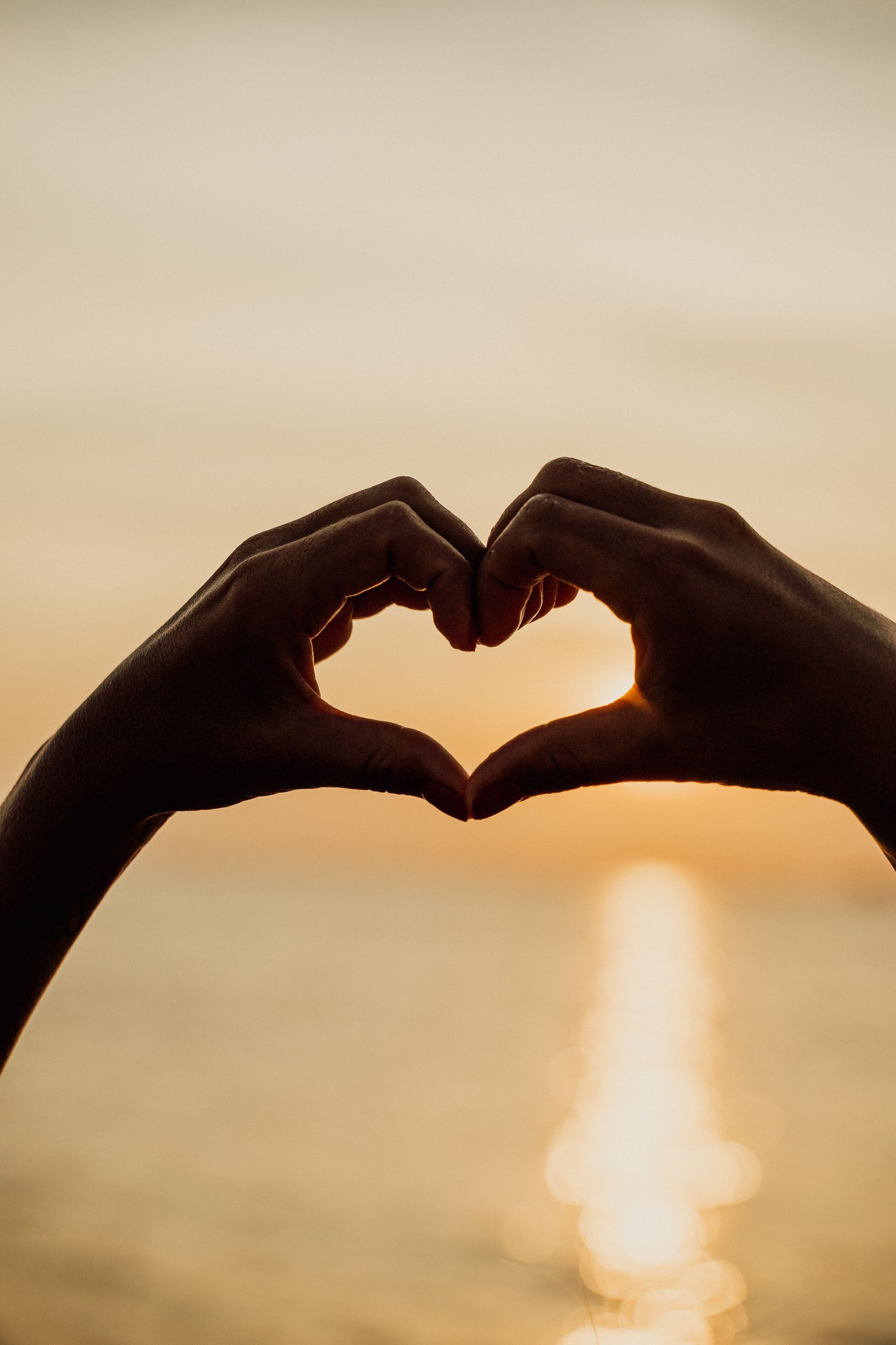 hands in the shape or a heart with sunset - Adult Therapy on Wurtulla, QLD