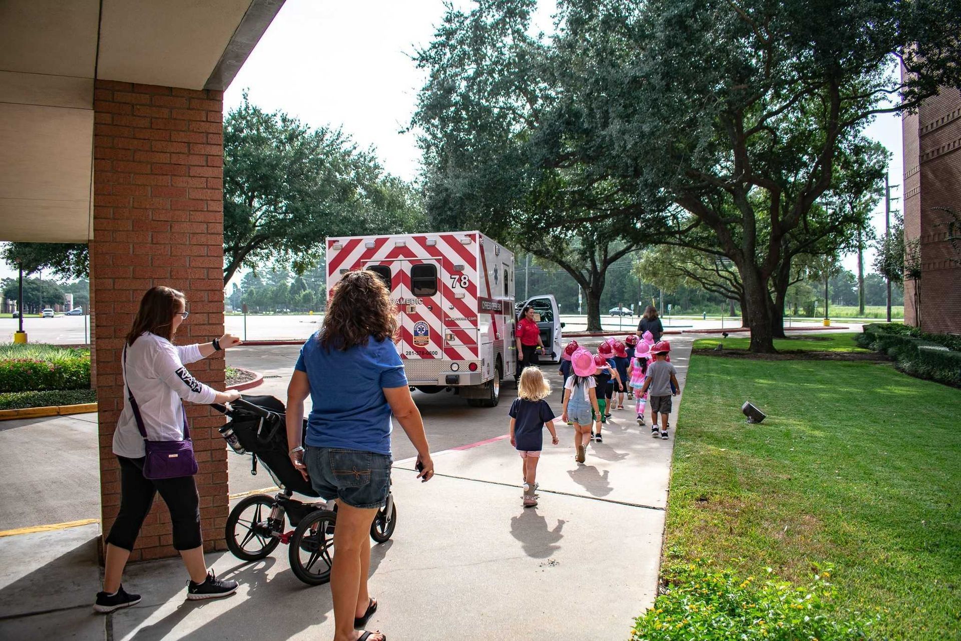 A group of people are walking towards an ambulance.