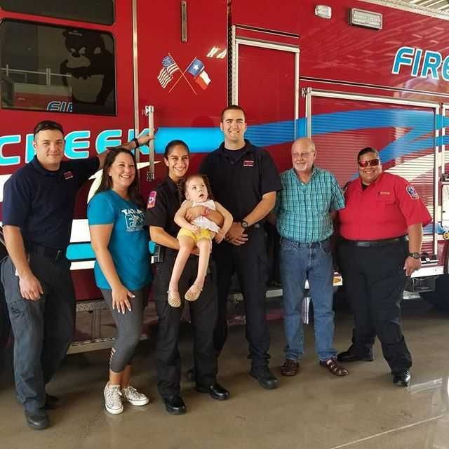 A group of people standing in front of a fire truck