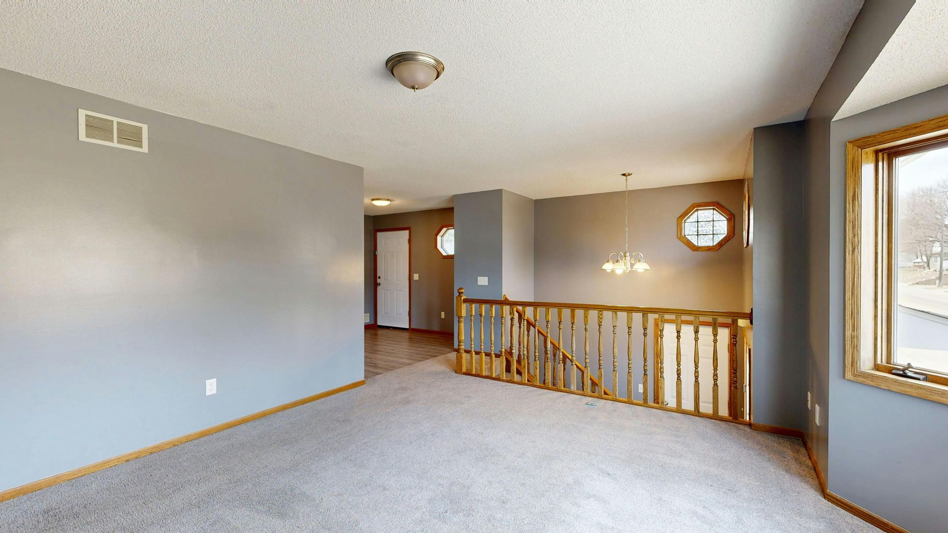 A yellow wet floor sign and a janitorial cleaning cart in a bright, modern office hallway.