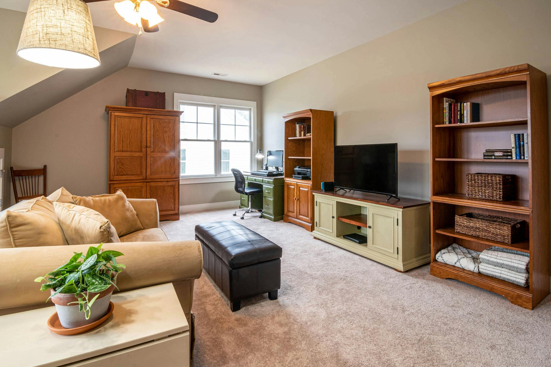 A modern, empty conference room with a long table, ergonomic black chairs, and light-toned wood flooring and wall panels.