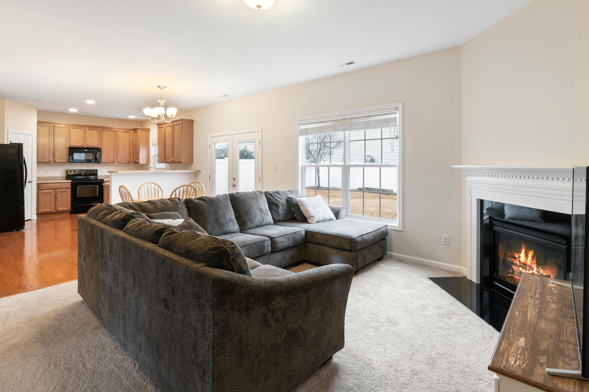 A yellow wet floor sign and a janitorial cleaning cart in a bright, modern office hallway.