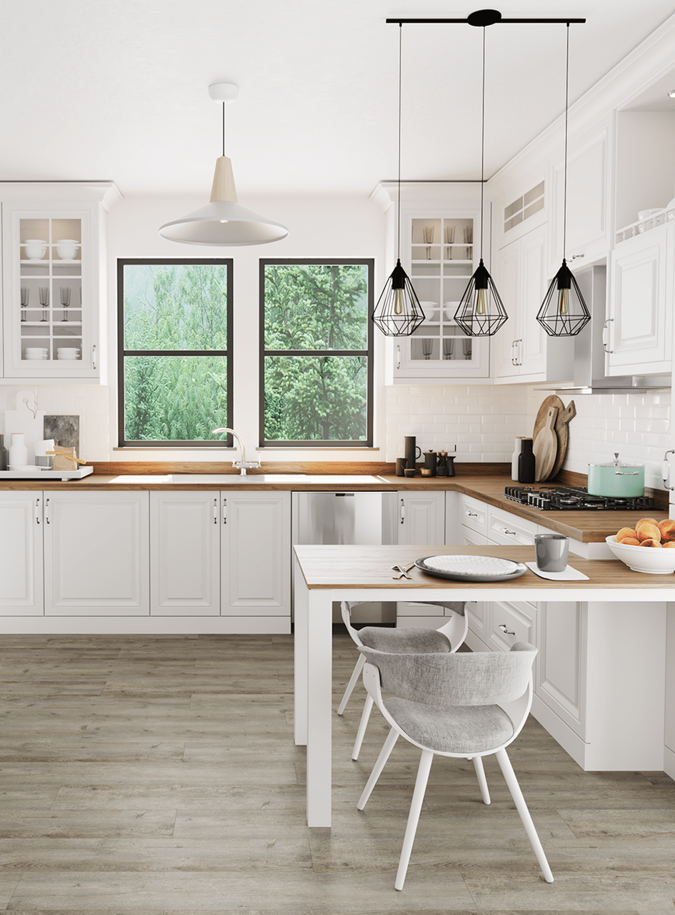 Modern white kitchen with wooden countertops, gray flooring, two windows, and hanging pendant lights over a small table.