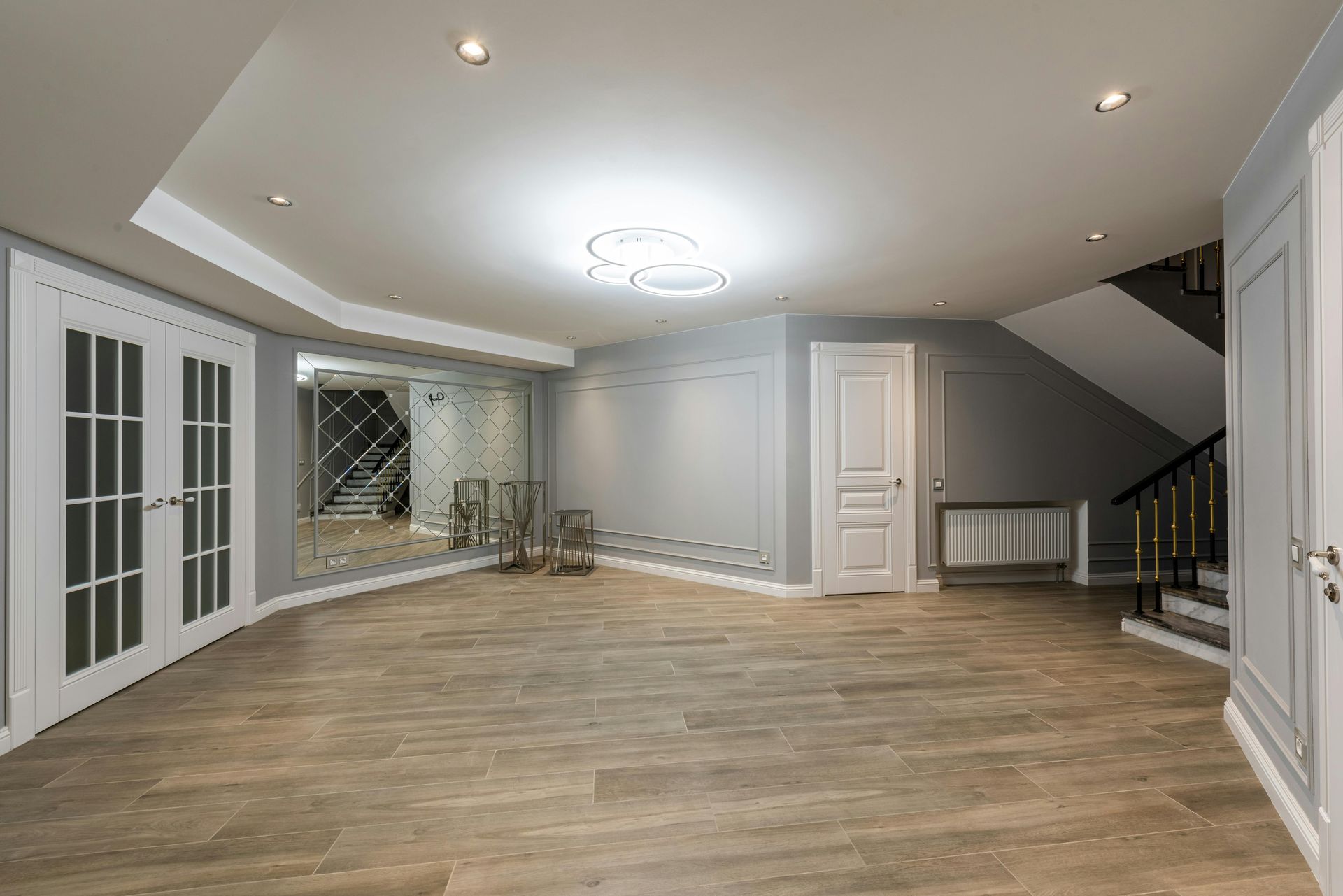 A yellow wet floor sign and a janitorial cleaning cart in a bright, modern office hallway.