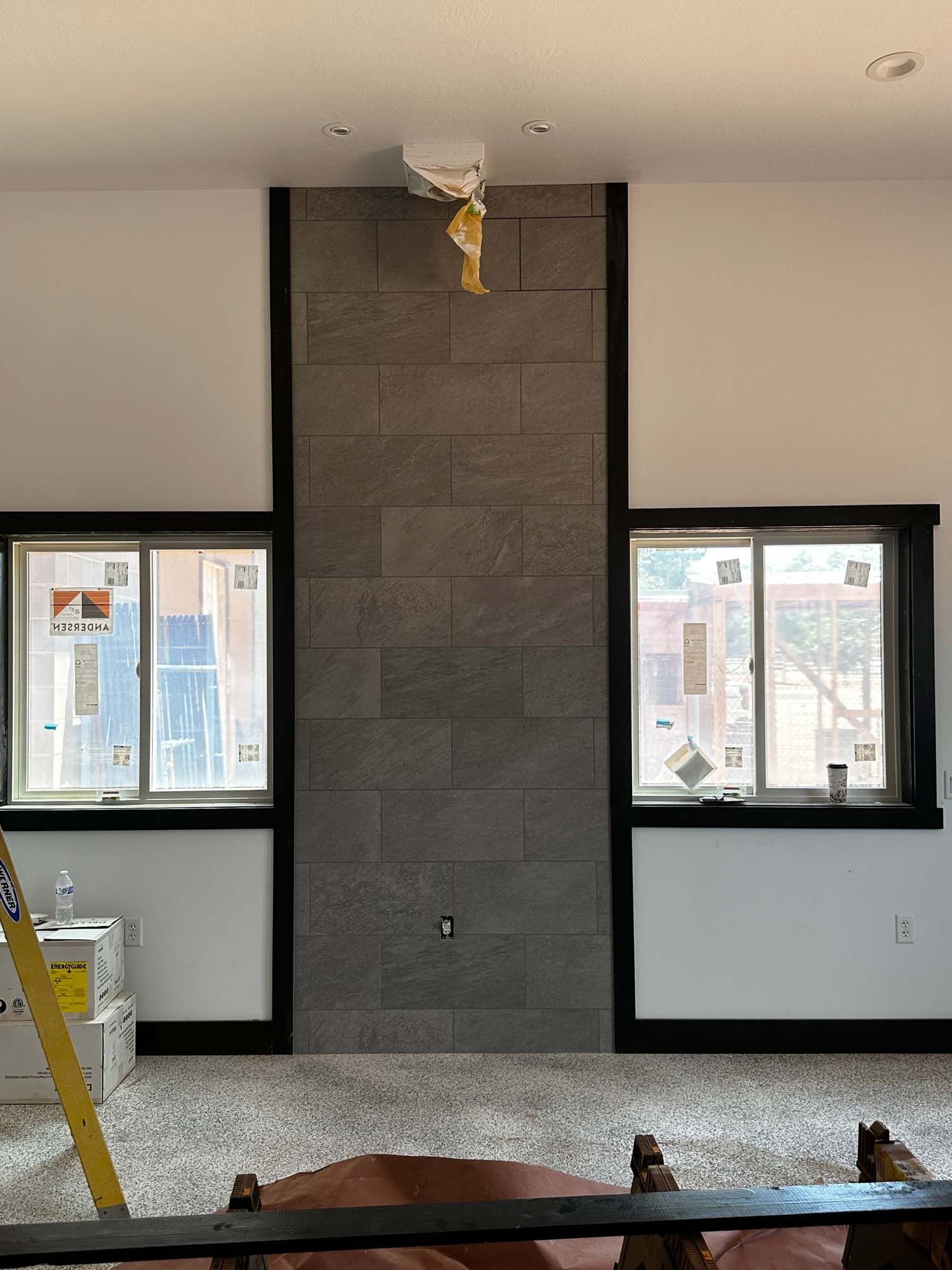 A living room with a fireplace and a lot of windows.