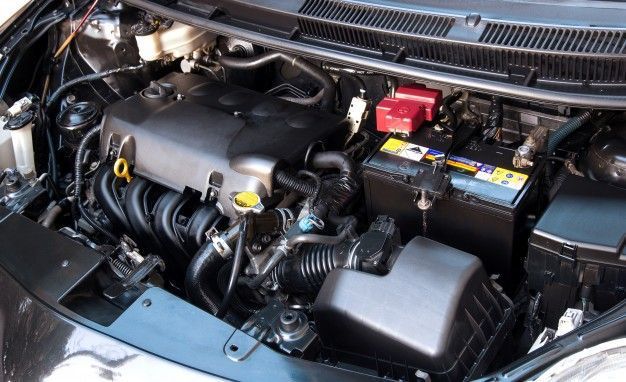 The engine of a car is shown with the hood open.