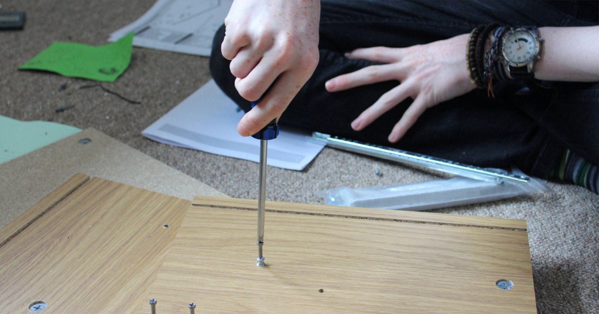 Handyman Assembling Flatpack Furniture In A Living Room Caloundra