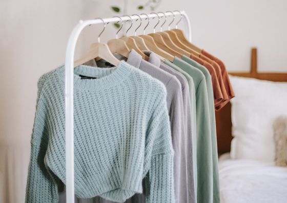 a colourful garment rack, nicely organised by colour tone