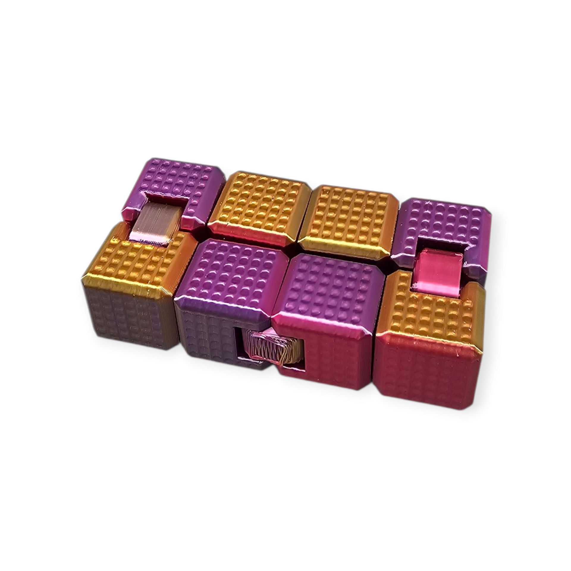Kleurrijk, in elkaar grijpend fidget cube-speelgoed met gouden en paarse blokken.