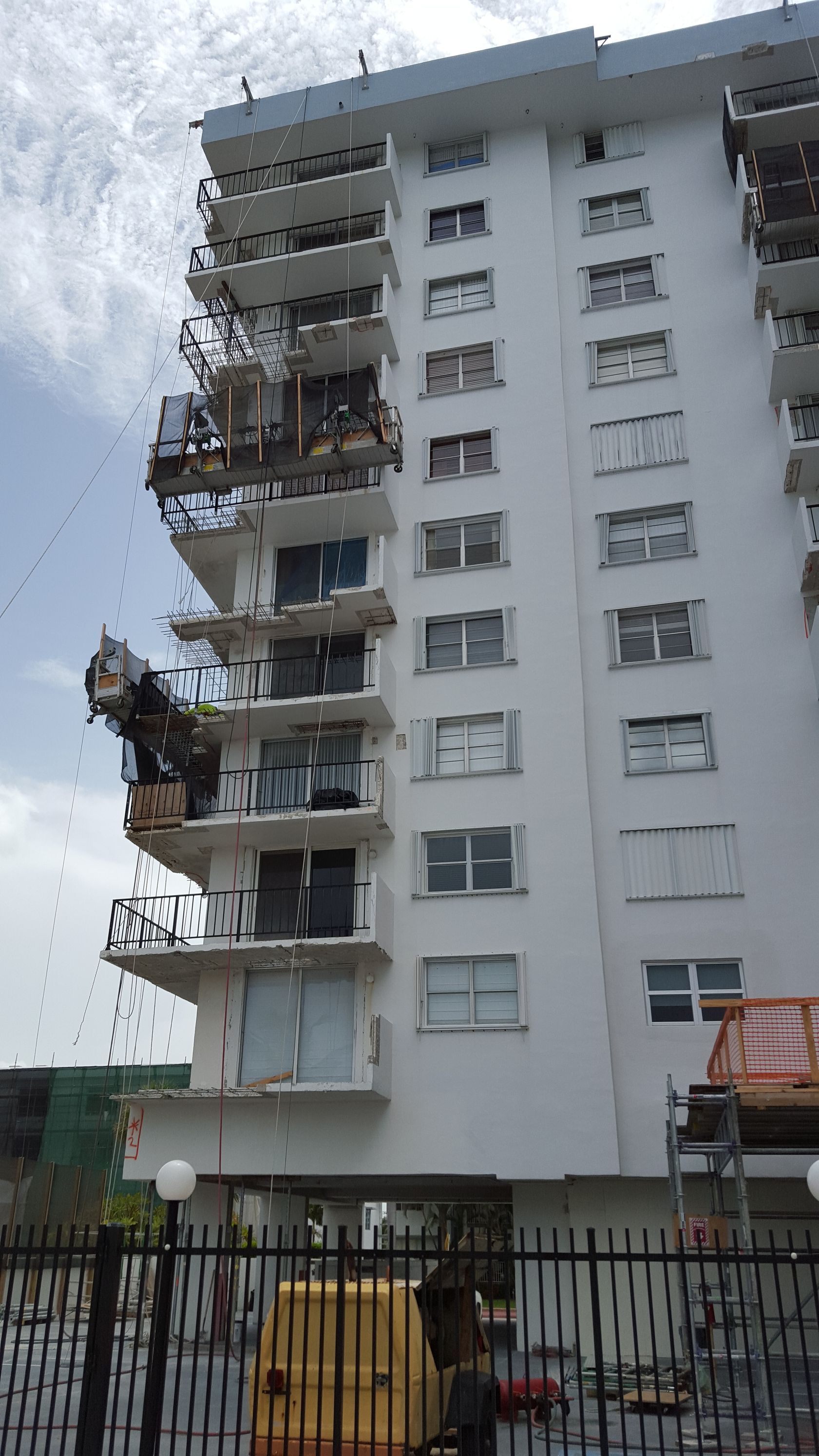 A tall building with a lot of windows is being demolished