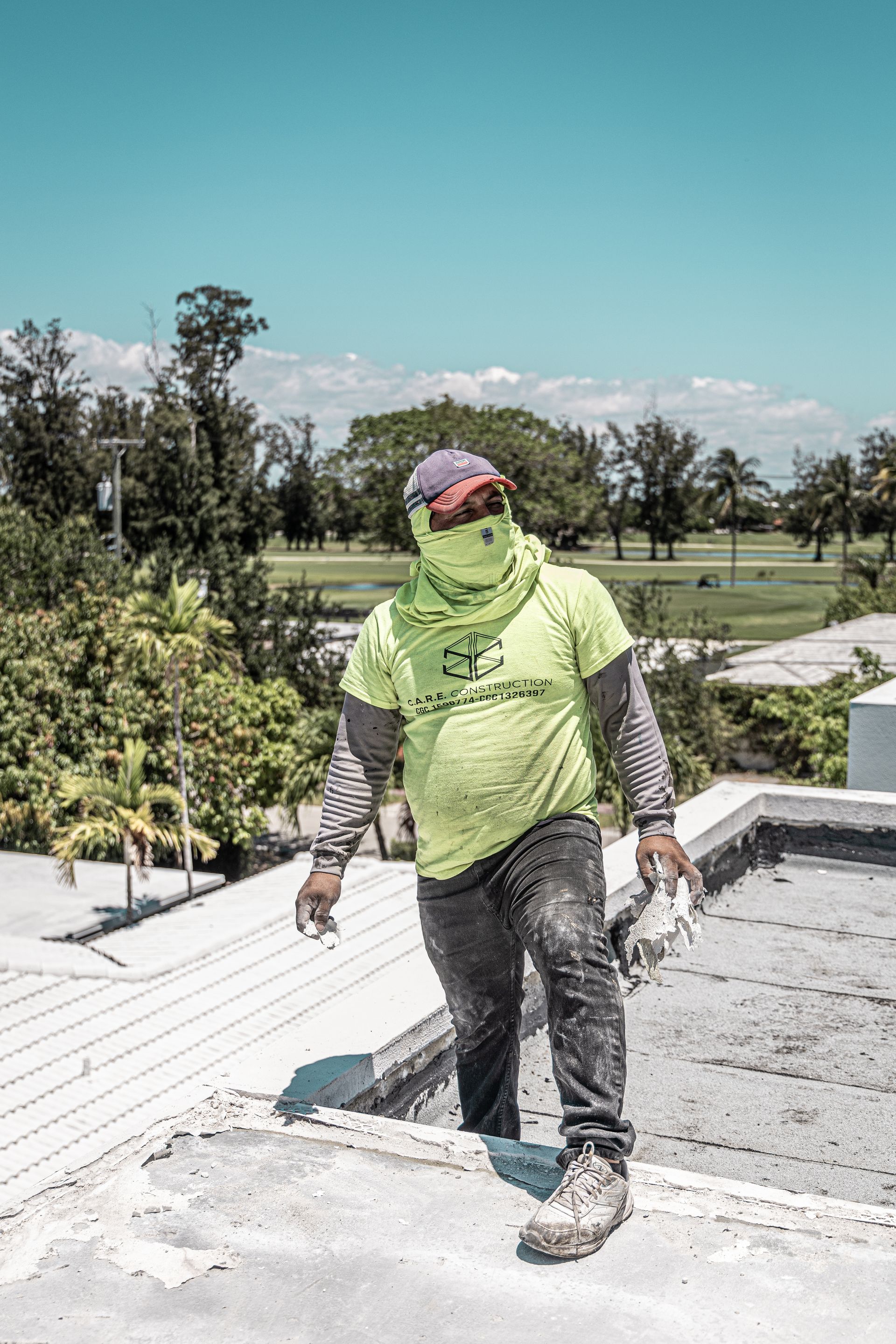 A roofer standing on top of a roof.