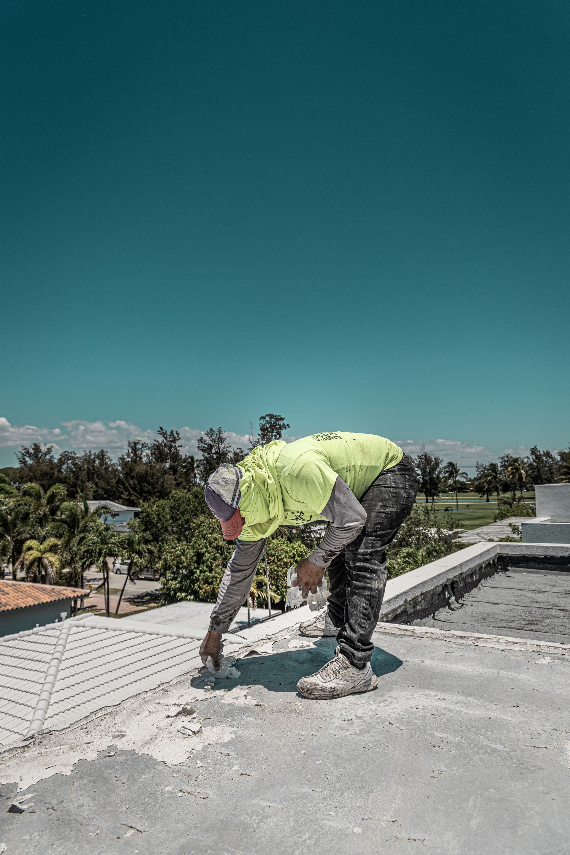 A man is working on the roof of a building.