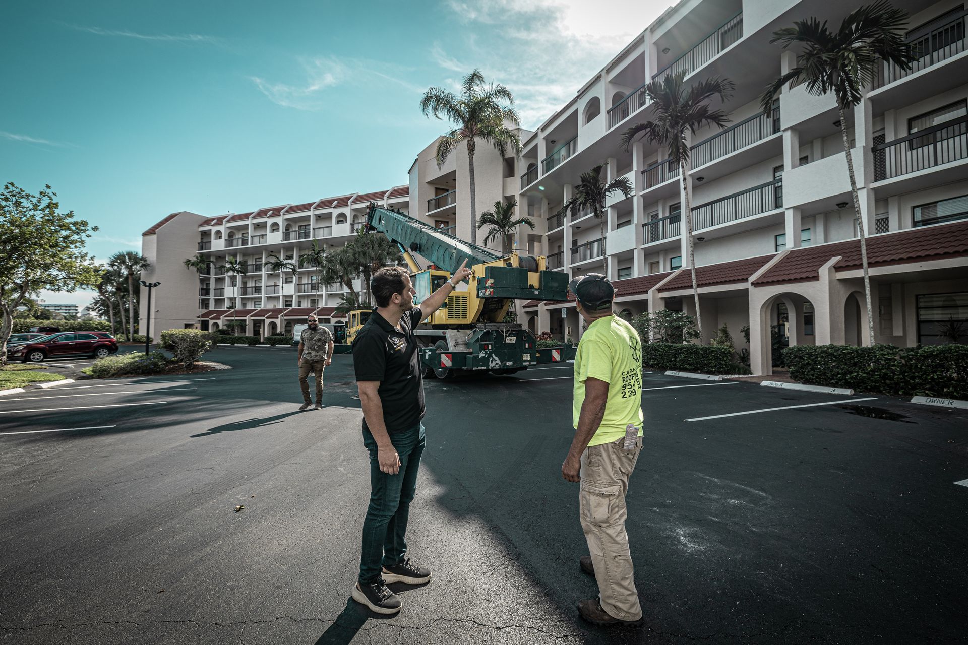 Two men are standing in front of a building talking to each other.