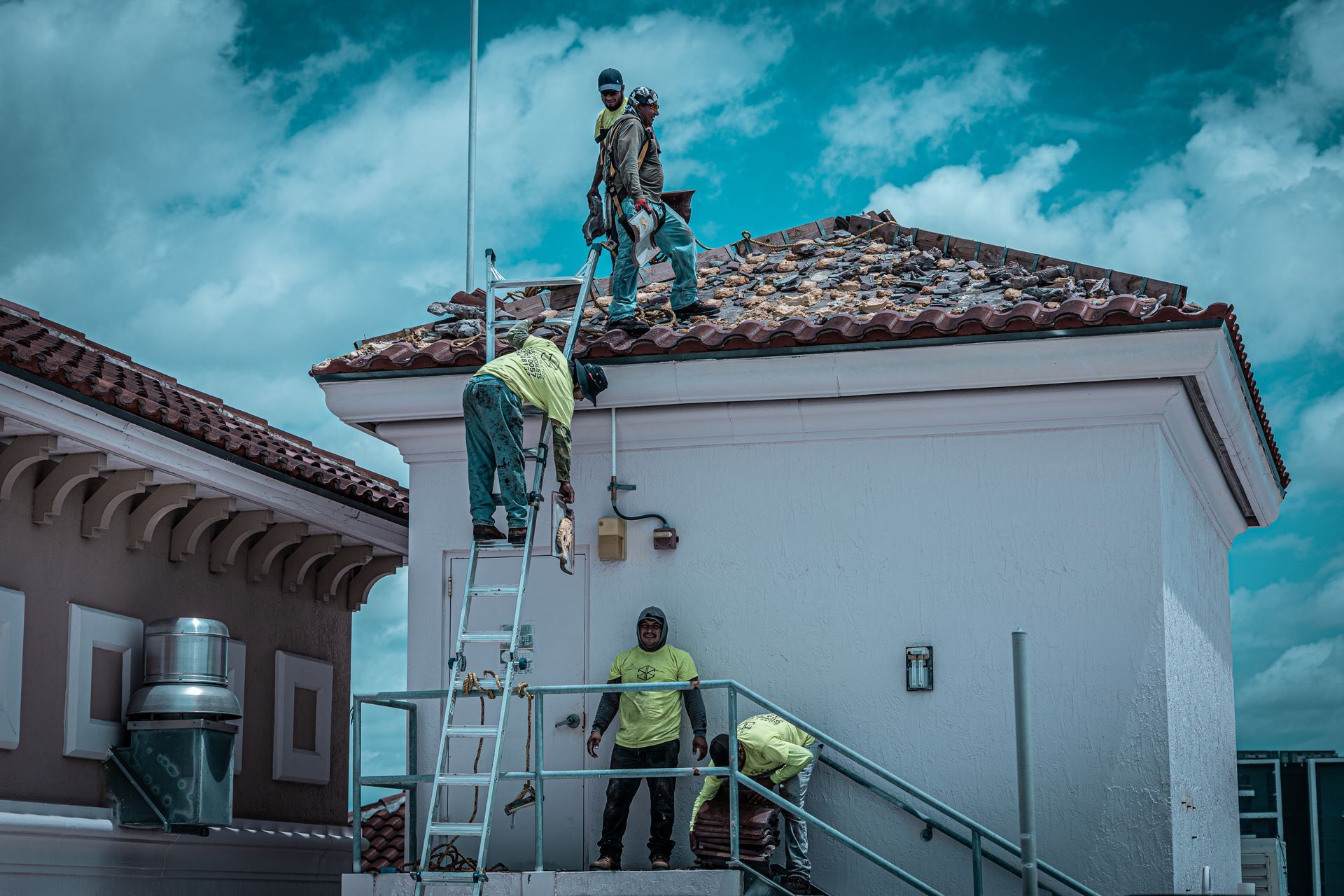 A group of men are working on the roof of a building.