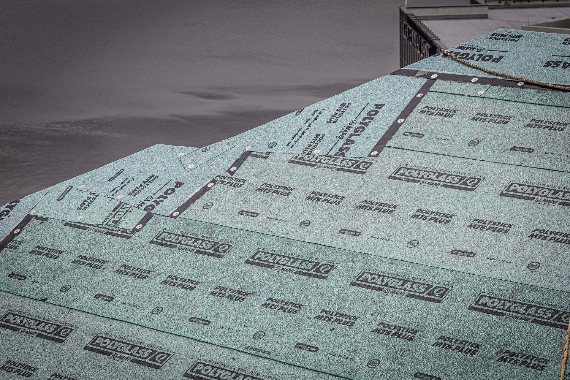 A close up of a roof with a lot of shingles on it.